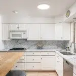 Cocina premium iluminada con luz natural real mediante tubo solar Solatube en el techo sin obras